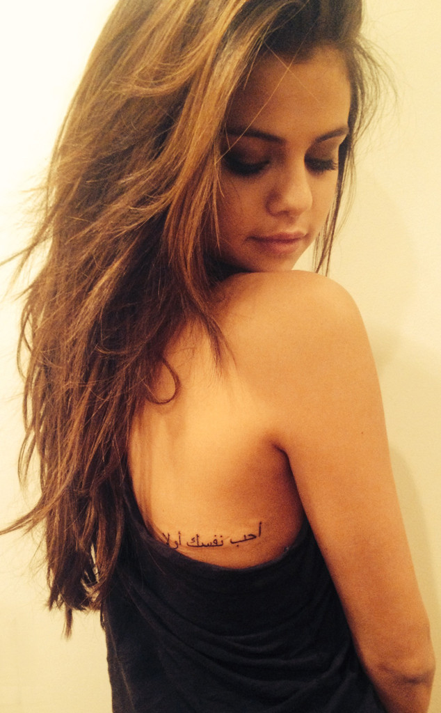 Pictures of Selena Gomez's new tattoo have come out and apparently she absolutely adores her new ink. The tattoo which is in Arabic means 'Love Yourself First' after being translated it means love yourself. The tat is in on the right side of the middle of her back. She reportedly had the ink for over a month now. To check out the 'Come and Get It' singer's new tat CLICK HERE!